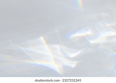  Crystal prism rainbow light refraction texture on white wall background. Organic drop diagonal holographic flare on a white wall. Water shadows for natural light overlay effects - Shutterstock ID 2327252245