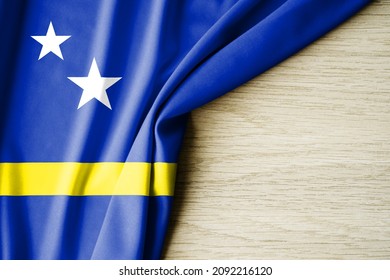Curacao flag. Fabric pattern flag of Curacao. 3d illustration. with back space for text. Close-up view.