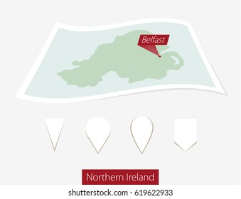 Curved paper map of Northern Ireland with capital Belfast on Gray Background. Four different Map pin set. Raster copy.