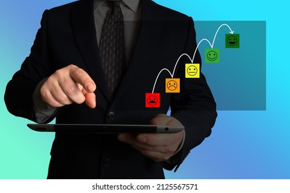 Customer Or Employee Or Stakeholder Satisfaction. Businessman Holding A Tablet, Looking At A Screen Showing Incremental Improvement In Customer Satisfaction.