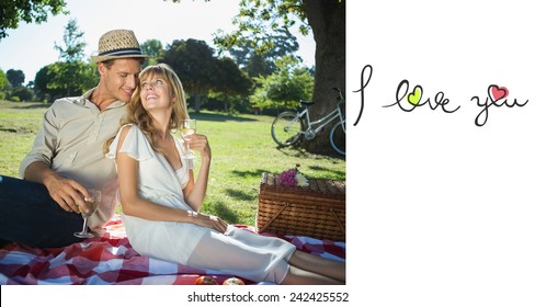 Cute couple drinking white wine on a picnic smiling at each other against i love you - Powered by Shutterstock