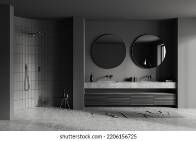 Dark Bathroom Interior With Double Sink And Round Mirror, Foot Towel On Grey Concrete Floor. Shower And Stool With Bath Accessories. 3D Rendering