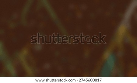 A dark brown background with a soft focus effect showcasing abstract elements. Thin, blurry streaks of yellow green and white light crisscross the image, creating a sense of depth and.