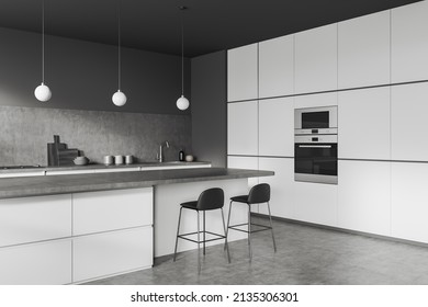 Dark Cooking Interior With Bar Chairs And Island On Grey Concrete Floor, Side View, Sink. Luxury Kitchen With Kitchenware And Oven, 3D Rendering