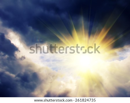 Dark dramatic sky with heavy clouds and bright yellow light.