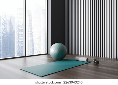 Dark fitness gym interior with exercise mat, ball and dumbbell. Grey wall, oak wooden floor, panoramic window. Concept of place for yoga, gymnastics, training, meditating. 3d rendering - Powered by Shutterstock