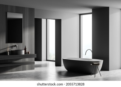 Dark Grey Bathroom Interior With Oval Bathtub, Wooden Wall With Floating Vanity, Mirror And Two Floor To Ceiling Windows On Background. Concrete Floor. Concept Of Modern Hotel Design. 3d Rendering