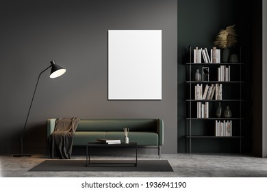 Dark Grey Modern Living Room Interior Furnished By Green Sofa, Coffee Table, Bookshelf And One Empty White Posters On Black Wall. Concrete Floor. Home Library Concept. 3D Rendering