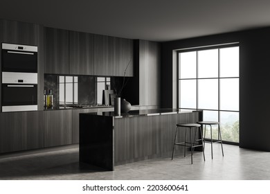 Dark Kitchen Interior With Bar Stool And Island, Side View, Grey Concrete Floor. Kitchenware And Minimalist Decoration, Cooking Corner With Panoramic Window On Countryside. 3D Rendering