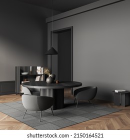 Dark Living Room Interior With Armchairs And Black Wooden Table, Shelf With Art Decoration, Carpet On Hardwood Floor. Mockup Copy Space Grey Wall, 3D Rendering