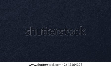 Dark navy blue background with a subtle textured finish. The background is deep navy, creating a rich and elegant style. Desktop wallpaper background with copy space.