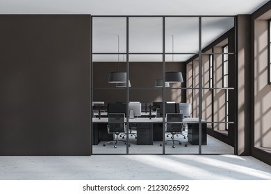 Dark Office Room Interior Behind Glass Doors, Armchairs With Desktop Pc On Table, Grey Concrete Floor. Window With Sunlight. Copy Space Brown Wall, 3D Rendering