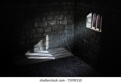 Dark prison cell illuminated only by moonlight