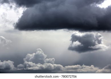 Dark rain clouds in the sky on a sunny day. 