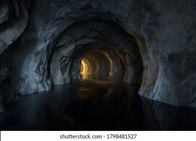 The dark rock tunnel and light illuminated in the end  3d rendering  Computer digital drawing 