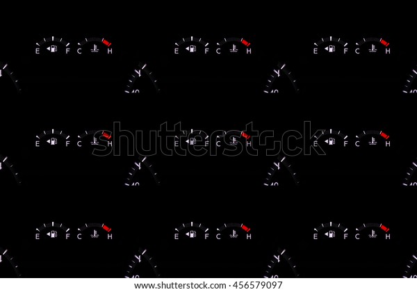 dashboard gasoline indicator in car shows full\
tank on black\
background