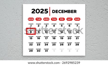 The date December 8th marked with a red cursor on the wall calendar 2025