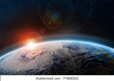 Dawn over the planet. A view from outer space to the surface of the Earth. Hurricane over the ocean. Elements of this image furnished by NASA