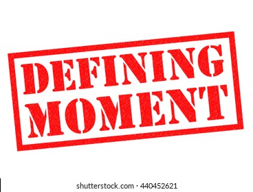 DEFINING MOMENT Red Rubber Stamp Over A White Background.