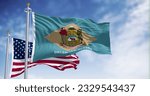 Delaware state flag waving in the wind with the National flag of the United States on a clear day. 3d illustration render. Fluttering fabric