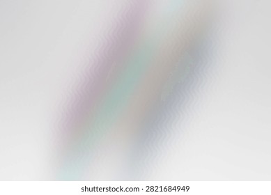 A delicate abstract background showcasing soft, iridescent pastel wavy lines that blend together to create a smooth, ethereal visual effect.