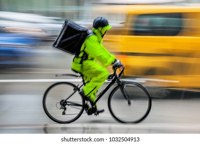 Delivery On The Bike In Traffic On The City Roadway  Motion Blur In The Rain