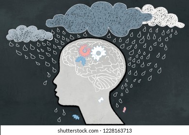 Depression Concept With Heavy Rain Directly Aimed At Depressive Human Profile With A Broken Brain. Illustrated With Chalk On Blackboard