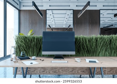Desktop computer with blank screen on wooden desk in modern office interior with green plants, large windows, and city view. Contemporary workspace. 3D Rendering.
