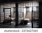 In a desolate prison cell, the rays of sunlight pour through the open window, casting a warm and radiant glow upon the bed. This image captures the juxtaposition of freedom and confinement.