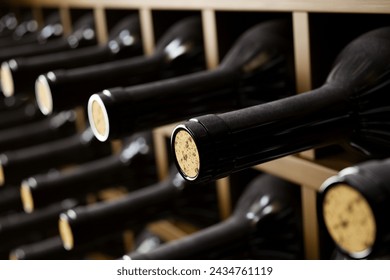 A detailed view of premium wine bottles with visible corks neatly lined up in an elegant wooden rack, showcasing a sophisticated wine collection in a traditional cellar setting. - Powered by Shutterstock