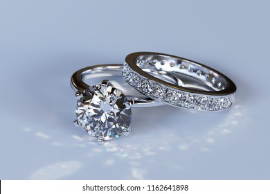 Diamond Wedding Set - Solitaire Engagement Ring, Eternity Ring On Light Blue Background. 3D Illustration