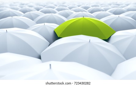 Different, unique and standing out of the crowd green umbrella