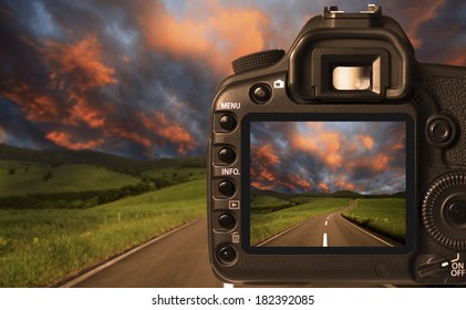 Digital camera taking picture of dramatic sky