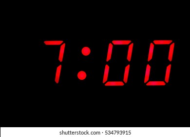 Digital clock closeup displaying 7:00 o'clock
