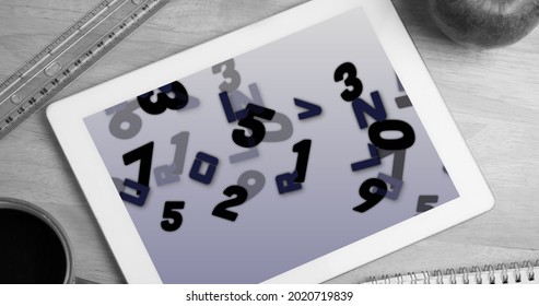 Digital Image Of Multiple Numbers And Alphabets On Screen On Digital Tablet On Wooden Surface. School And Education Concept