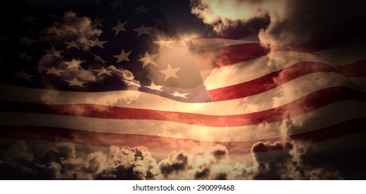 Digitally Generated American Flag Rippling Against Dark Sky With White Clouds