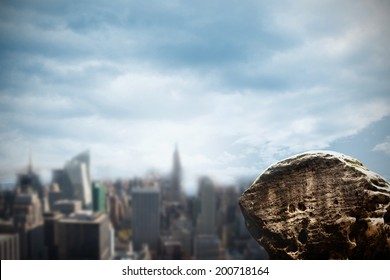 Digitally generated large rock overlooking urban city