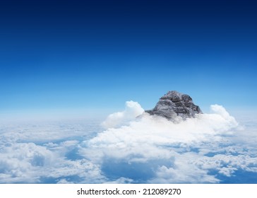Digitally Generated Mountain Peak Through The Clouds