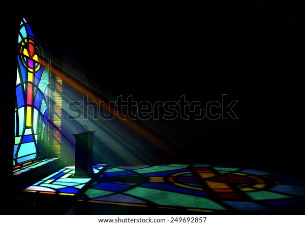 A dim\
old church interior lit by suns rays penetrating through a\
colourful stained glass window in the pattern of a crucifix\
reflecting colours on the floor and a speech\
pulpit