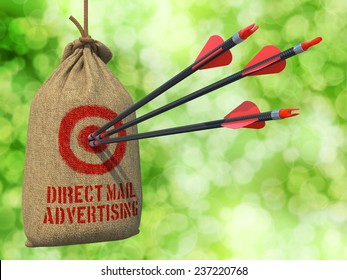 Direct Mail Advertising - Three Arrows Hit In Red Target On A Hanging Sack On Natural Bokeh Background.