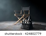 Director Chair, Movie Clapper and Megaphone in the volumetric light on a black background. 3d Rendering