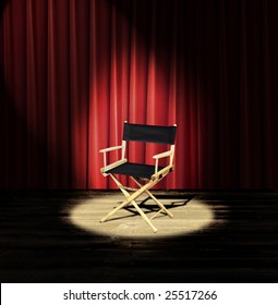 A Directors Chair On A Stage With A Red Curtain And Spotlight