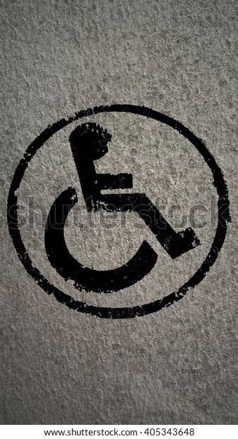 disabled icon\
sign, black old fabric\
background.
