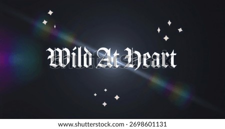 Displaying gothic Wild At Heart text on studio-style backdrop, with rainbow flare and diamond stars. Dramatic, mystical, cosmic, vibrant, decorative, fantasy, artistic