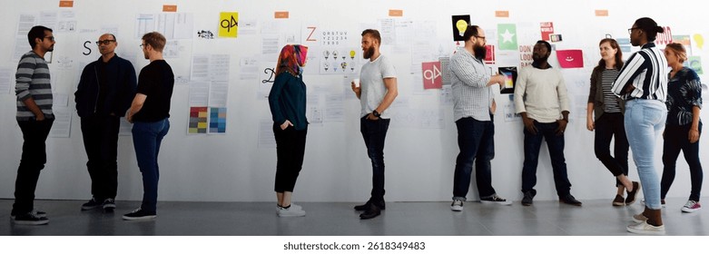 Diverse group discussing design ideas. People engaged in creative dialogue. Team brainstorming design concepts in a collaborative setting. Group of diverse people together.
