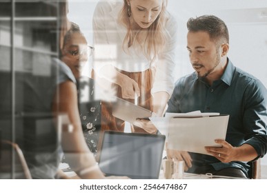 Diverse team in office, diverse ethnicity, male and female, collaborating on business project. Office teamwork, diverse group meeting, mixed ethnicity, male and female professionals. Business meeting. - Powered by Shutterstock