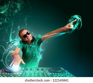 DJ with a mixer equipment to control sound and play music - Powered by Shutterstock