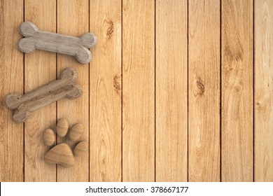 Dog Bones And Dog Paw On Wooden Background