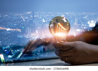 Double exposure of business woman hand holding lightbulb growth graph inside and building  in big city , idea to growth and win in business concept. 3D rendering

 - Powered by Shutterstock