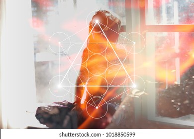 Double exposure collage with sacred geometry Metatron cube symbol , young beautiful woman in meditation and overlaying image of fire.